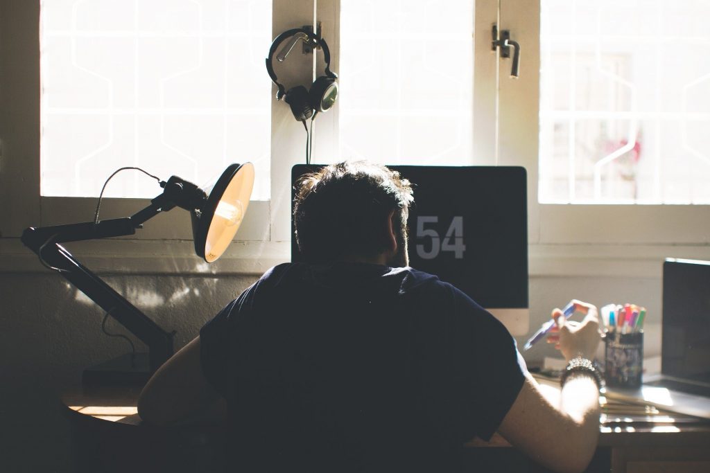 Man sitting at desk in front of computer working from home